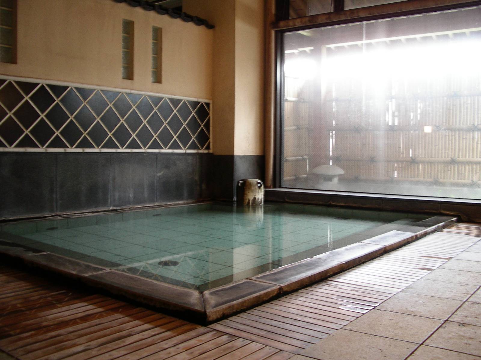 Large onsen bath filled with natural hotspring water.